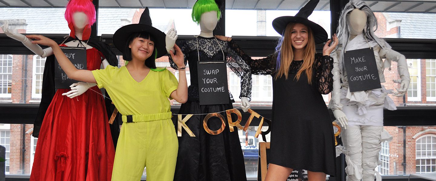 Two people in fancy dress stood with three mannequins, also in fancy dress, encouraging people to make their own Halloween costumes or buy them second hand.