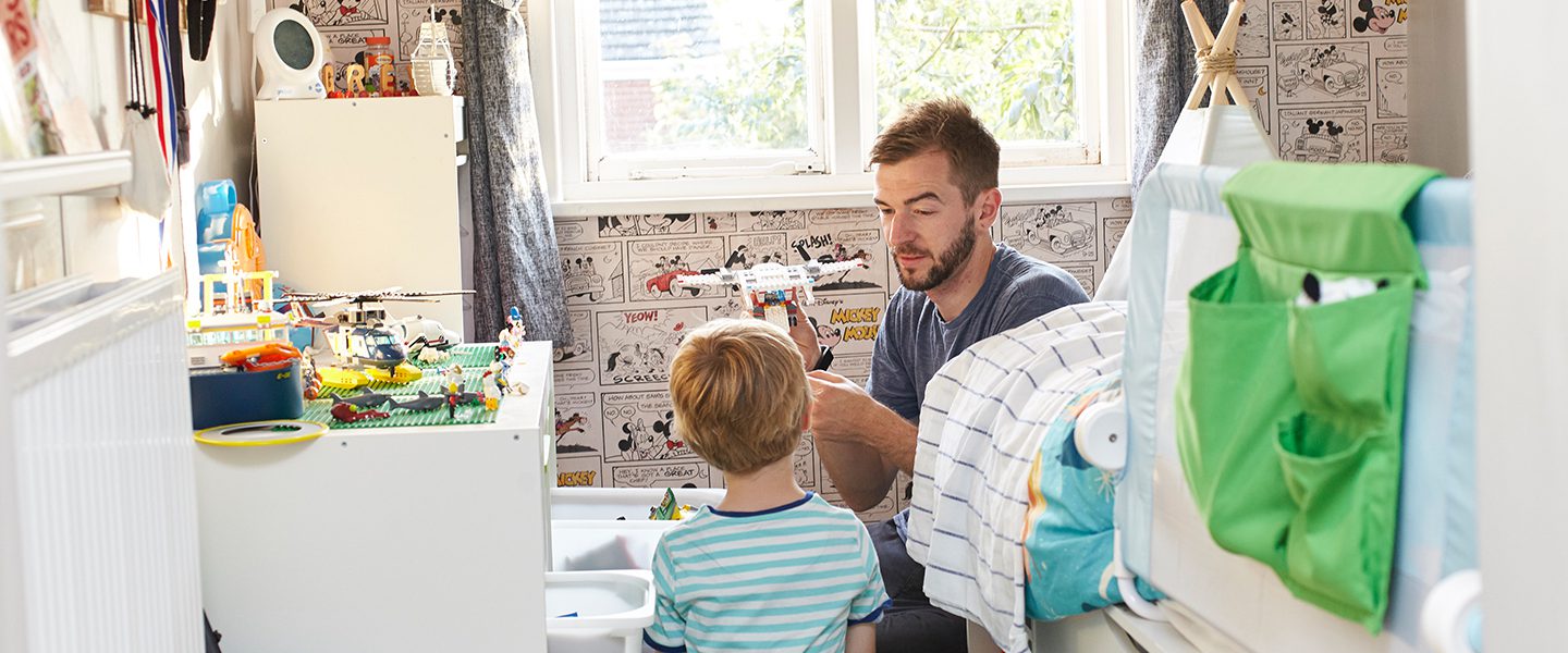 A doorway shot of a father and son playing in the son's bedroom | A&M Removals